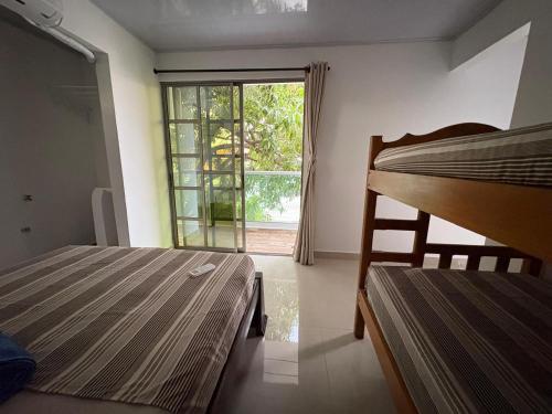 a bedroom with a bunk bed and a window at Maru apartamentos in Cartagena de Indias