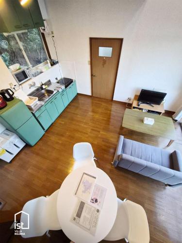 a view of a living room with a table and a kitchen at Designer Island Villa with Panoramic Sea Views in Bizen