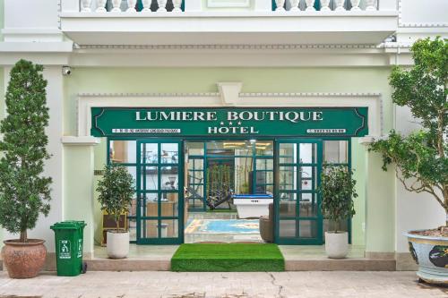 a entrance to a hotel with a green sign at Lumiere Boutique Phu Quoc Hotel in Phu Quoc