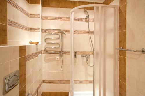 a shower with a glass door in a bathroom at MDK Hotel in Saint Petersburg