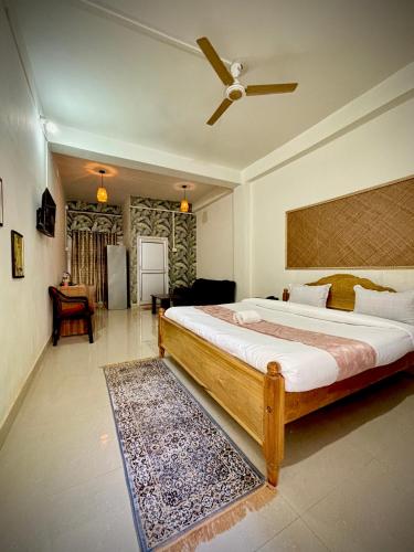 a bedroom with a bed and a ceiling fan at Victus Emporium in Guwahati