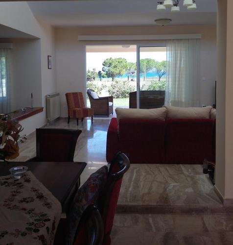 a living room with a couch and a table at Villa Leonidas in Mastichari