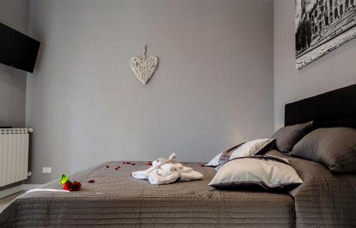 a bedroom with a bed with a stuffed animal on it at Villa Erasi in Fiumicino