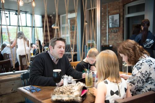 a group of people sitting at a table in a restaurant at The Ship & Trades in Chatham