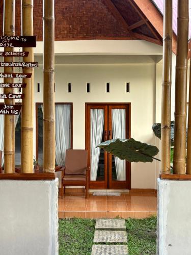 a house with a sign in front of it at Sumatran Ethical Expeditions and Trekking in Bukit Lawang