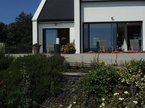 a house with a garden in front of it at On the Rocks B&B in Greencastle