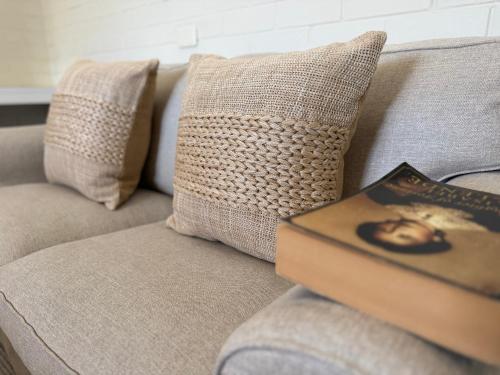 a book sitting on top of a couch with a pillow at Ballina Travellers Lodge in Ballina