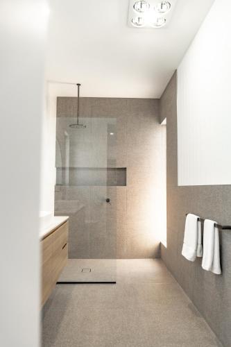a bathroom with a shower and a sink at Discover - Ebenezer Bicheno in Bicheno