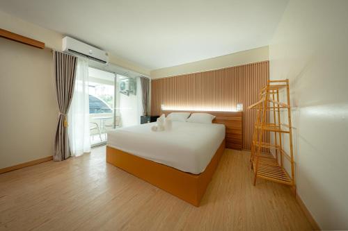 a bedroom with a bed with a ladder in it at The Nook Hotel in Chiang Mai