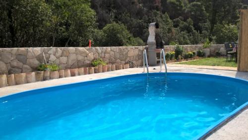 a person sitting in a chair in a swimming pool at Apartment Old village in Trstenik
