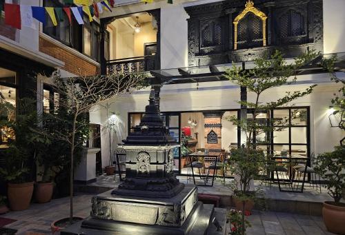 a lobby with a fountain in the middle of a building at Central Courtyard Thamel - Kathmandu's Best Kept Secret in Kathmandu