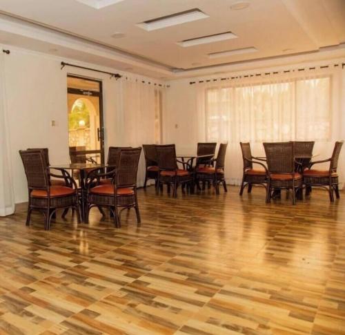 a dining room with chairs and a table in a room at Keriwest hotel in Kericho