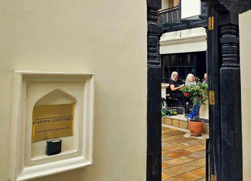 a window with a sign on the side of a building at Central Courtyard Thamel - Kathmandu's Best Kept Secret in Kathmandu