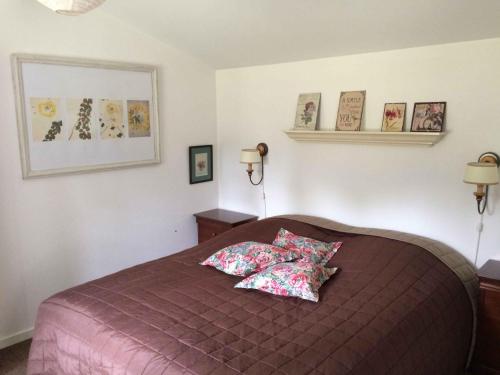 a bedroom with a bed with two pillows on it at Child-Friendly Holiday 500 Meters From The Beach in Nykøbing Sjælland