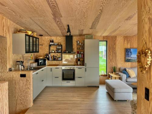 a kitchen with white cabinets and a stove at Architect-Designed House Near Sea On Resö in Resö