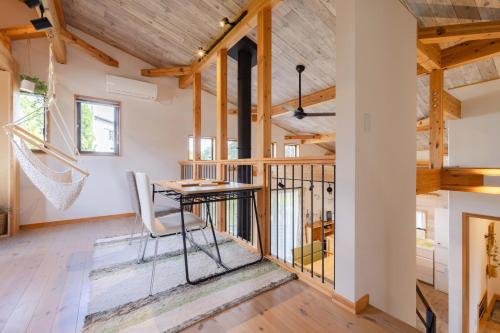 a home office with a desk in a room with wooden ceilings at Villa Katarima 西軽井沢 in Miyota