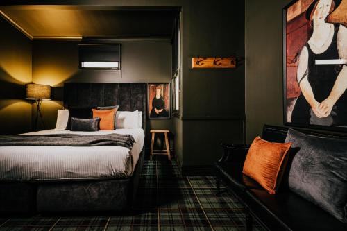 a bedroom with a bed and a painting on the wall at The Amalfi House in Hepburn Springs