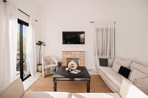 a living room with a couch and a fireplace at Zeus Holiday Home in Pissouri