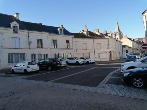 a street with cars parked in front of buildings at Quiet apartment Chamaillard 2 in L'Ile-Bouchard