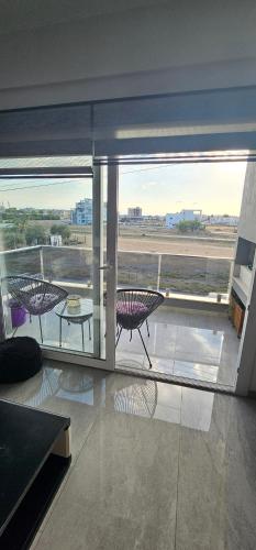 a room with a balcony with a view of an airport at Modern apartment in Lefkosa Turk