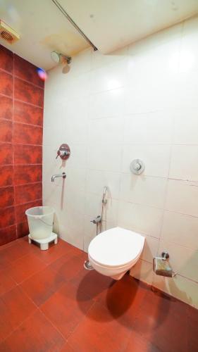 a bathroom with a toilet and a sink at HOTEL GARNET in Durg