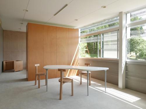 a table and chairs in a room with a window at OGUNI S HOUSE 2F Designed by Toyo Ito in Oguni
