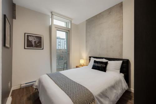 una camera da letto con un letto grande e una finestra di Corporate Stays The Wedge Studio a Victoria