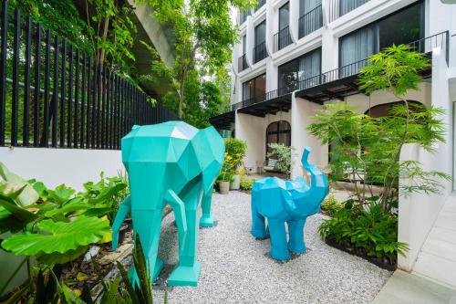 a blue elephant statue in front of a building at Hotel Bangkokian in Bangkok
