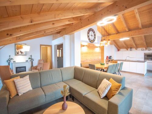 a living room with a couch and a table at Luxury penthouse with Balcony, Ski Storage, Carport, Lift in Brixen im Thale