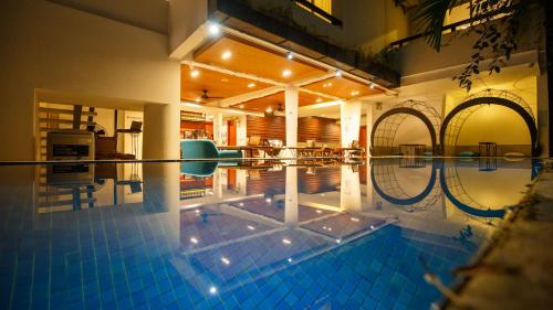a large swimming pool in a house with at Cheers Social Apartment & Hotel BKK1 in Phnom Penh