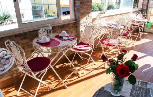 a group of chairs and tables on a patio at Villa Erasi in Fiumicino