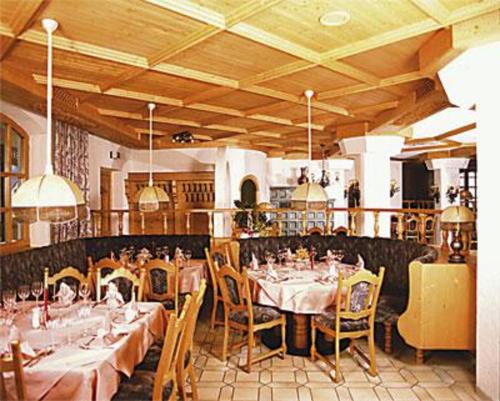 ein Restaurant mit Tischen und Stühlen in einem Zimmer in der Unterkunft Gasthof Genosko in Spiegelau