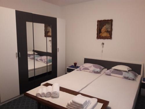 a bedroom with a bed and a large mirror at Rina Apartments in Labin