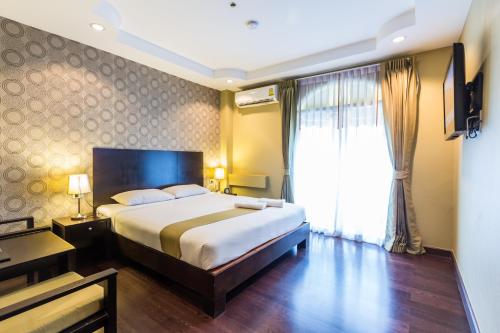 เตียงในห้องที่ Zing Resort & Spa