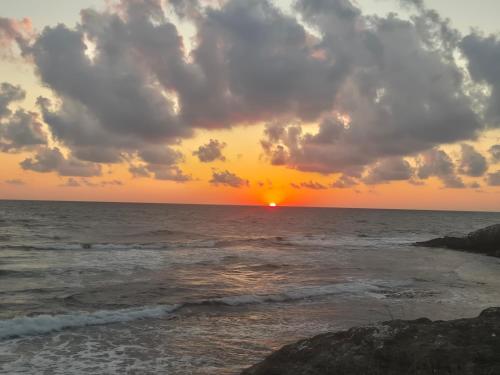 a sunset on the beach with the ocean at Guest House Compass in Lozenets