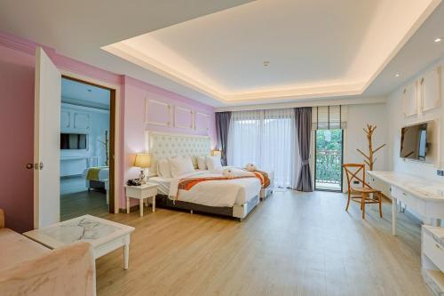a bedroom with a bed and a living room at Aqua Resort Aonang Krabi in Ao Nang Beach