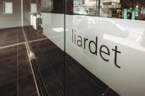 a glass door with the word afraid written on it at Liardett Penthouse - Inner city accommodation in New Plymouth