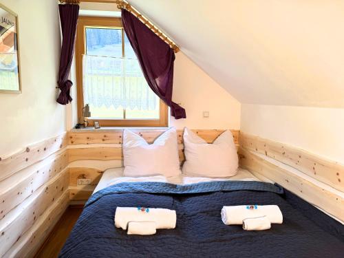 a bedroom with two beds and a window at Apartment BergWiese 225 in Donnersbachwald