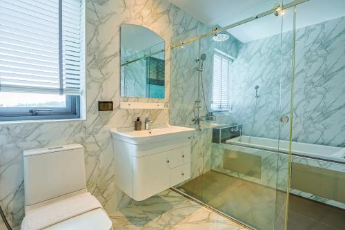 a bathroom with a toilet and a sink and a shower at Aqua Resort Aonang Krabi in Ao Nang Beach