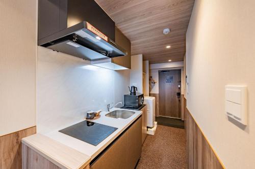 Η κουζίνα ή μικρή κουζίνα στο Apartment Hotel 11 Shinimamiya 1