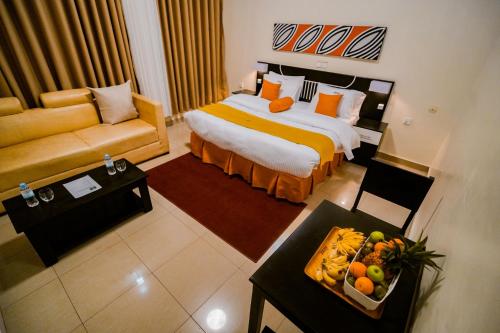 a hotel room with a bed and a couch at Murugano Village Hotel in Taba