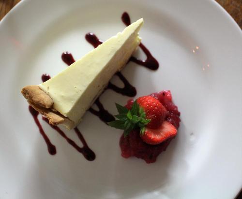 a piece of dessert on a plate with strawberries at The George in Bradford on Avon