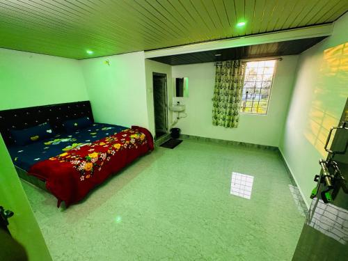 a bedroom with a bed in the corner of a room at Sunrise Resort in Araku