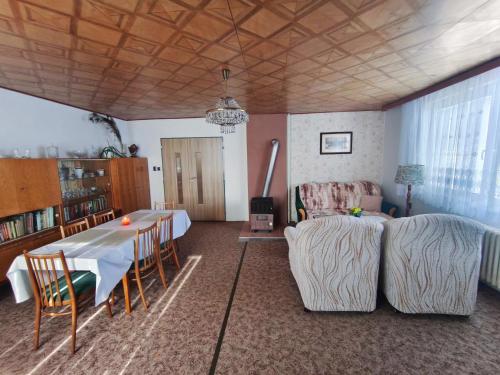 a living room with a table and a couch at RD ve Vilémovicích U Macochy v Moravském krasu in Jedovnice