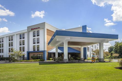 a hotel with a blue and white building at Hampton Inn New Bern in New Bern