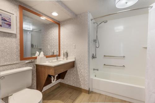 a bathroom with a toilet and a sink and a shower at Hampton Inn New Bern in New Bern