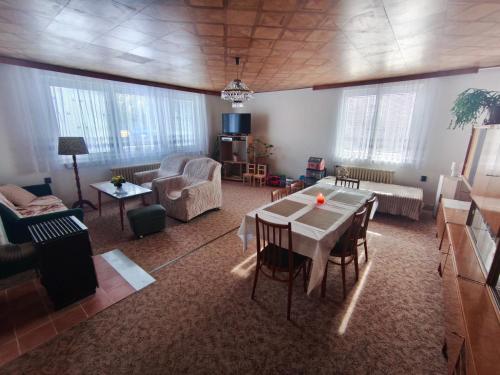 a large living room with a table and chairs at RD ve Vilémovicích U Macochy v Moravském krasu in Jedovnice