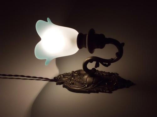 an old fashioned lamp with a white light on it at San Demetrio in Catania