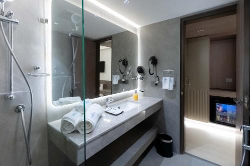 a bathroom with a sink and a shower at Emerald Luxe A Boutique Hotel in Sohāna