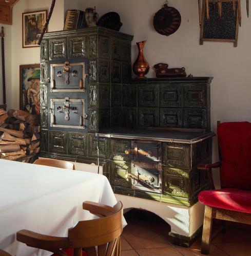 an old green dresser in a room with a table at Hotel Křížový vrch in Jeseník